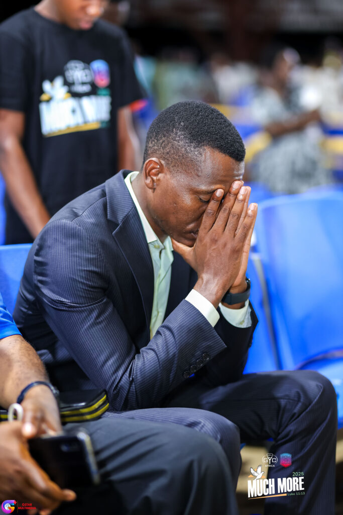 A young man in prayer with his head bowed