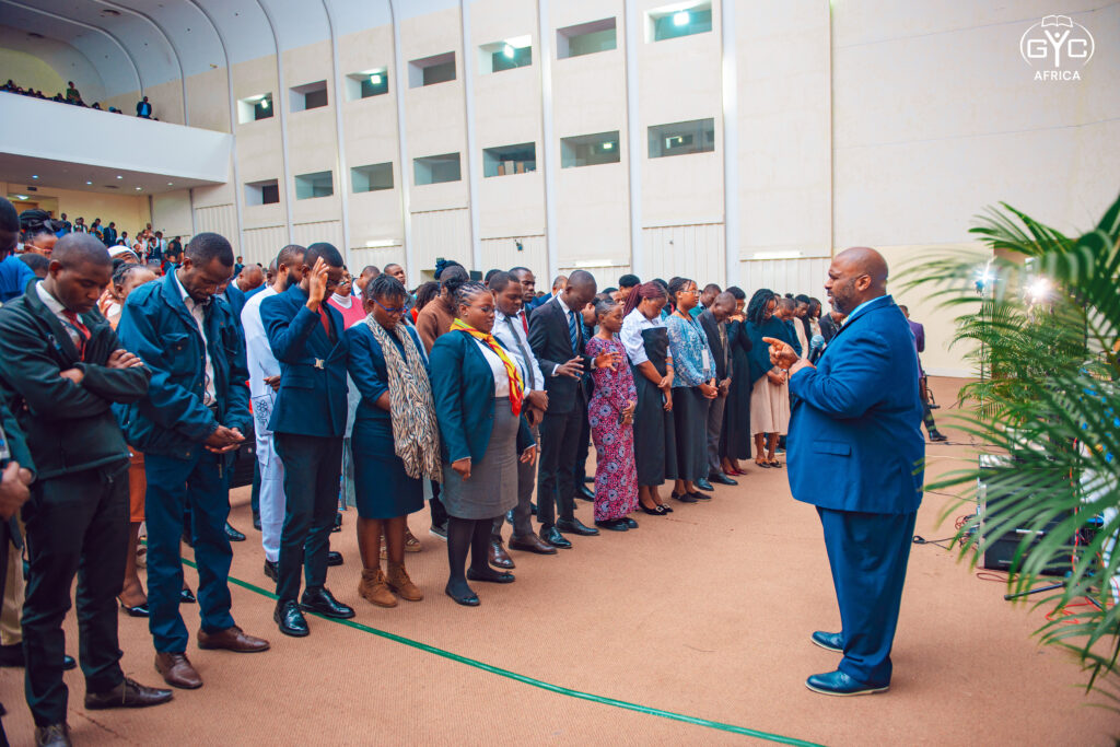 Delegates bowed in prayer as a speaker leads them