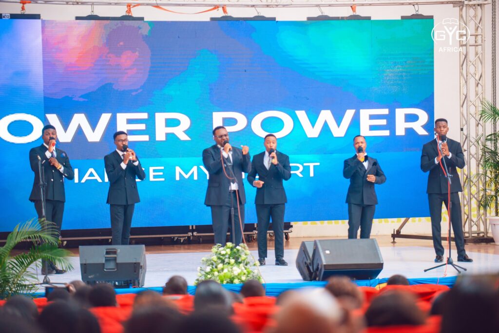 A vocal group sings on stage during Sabbath worship